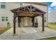 The backyard features a covered patio with a concrete slab, grill, and green hose at 3573 Stonebranch Ln, Loganville, GA 30052