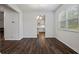 Dining room with hardwood floors, modern chandelier, and views to the kitchen at 3573 Stonebranch Ln, Loganville, GA 30052