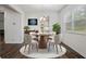 Dining room with hardwood floors, modern chandelier, and views to the kitchen at 3573 Stonebranch Ln, Loganville, GA 30052