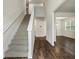 Bright entryway featuring hardwood floors, staircase, and an open floor plan at 3573 Stonebranch Ln, Loganville, GA 30052
