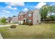 Charming two-story brick home with a well-manicured front yard and colorful flower beds at 3573 Stonebranch Ln, Loganville, GA 30052