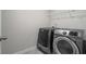 Laundry room featuring a new washer and dryer set and a wire shelf for storage at 3573 Stonebranch Ln, Loganville, GA 30052