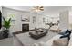 Bright living room with fireplace, ceiling fan, and open floor plan at 3573 Stonebranch Ln, Loganville, GA 30052