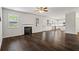 Open-concept living room with dark hardwood flooring and lots of natural light at 3573 Stonebranch Ln, Loganville, GA 30052