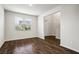 Living area with hardwood flooring, large window, and view into front entryway at 3573 Stonebranch Ln, Loganville, GA 30052