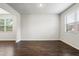 Bright living room with hardwood flooring and natural light from two large windows at 3573 Stonebranch Ln, Loganville, GA 30052