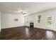 Spacious living room featuring hardwood flooring, a fireplace, and natural light at 3573 Stonebranch Ln, Loganville, GA 30052