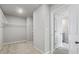 Walk-in closet with neutral paint, carpet, and adjustable shelving with an entry into a bathroom at 3573 Stonebranch Ln, Loganville, GA 30052