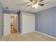 Bright bedroom with double closets, plush carpeting, and doorway to kitchen at 4535 Clipper Bay Rd, Duluth, GA 30096