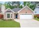 Charming one-story home featuring a manicured lawn, bay window, and a two-car garage at 4535 Clipper Bay Rd, Duluth, GA 30096