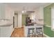 Bright kitchen featuring an island with breakfast bar, white cabinets, and green walls at 4535 Clipper Bay Rd, Duluth, GA 30096