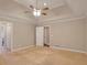 Spacious main bedroom with large windows, a ceiling fan, and neutral carpeting at 4535 Clipper Bay Rd, Duluth, GA 30096