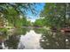 Scenic pond view surrounded by lush greenery and beautiful reflections on the water at 4535 Clipper Bay Rd, Duluth, GA 30096