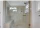 Modern glass enclosed shower featuring built-in bench and wall fixtures at 4535 Clipper Bay Rd, Duluth, GA 30096