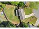 Aerial view of a property with a spacious, well-maintained yard, privacy fence, and mature trees at 660 Cranberry Ct, Roswell, GA 30076