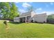 Spacious backyard featuring a covered patio, lush green lawn, and wood fencing for privacy at 660 Cranberry Ct, Roswell, GA 30076