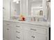 Bright bathroom featuring double sink vanity, marble countertop, and decorative mirrors at 660 Cranberry Ct, Roswell, GA 30076