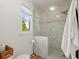 Stylish bathroom with glass shower, tile surround, and modern toilet at 660 Cranberry Ct, Roswell, GA 30076