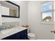 Elegant bathroom with marble countertop, stylish fixtures, and ample natural light at 660 Cranberry Ct, Roswell, GA 30076
