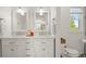Elegant bathroom featuring double sinks, marble countertop, and modern fixtures at 660 Cranberry Ct, Roswell, GA 30076