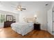 Tranquil bedroom with hardwood floors, ceiling fan, and large windows at 660 Cranberry Ct, Roswell, GA 30076