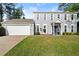 Charming two-story home featuring a well-maintained lawn and an attached two-car garage at 660 Cranberry Ct, Roswell, GA 30076