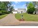 Lovely two-story home with a blue front door, a spacious lawn, and an extended driveway at 660 Cranberry Ct, Roswell, GA 30076