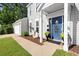 Inviting front entrance with blue door, manicured landscaping, and attached garage enhancing curb appeal at 660 Cranberry Ct, Roswell, GA 30076