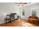 Bright home office with hardwood floors, ceiling fan, and ample natural light at 660 Cranberry Ct, Roswell, GA 30076