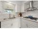 Well-lit kitchen with stainless steel appliances, stylish backsplash and ample counterspace at 660 Cranberry Ct, Roswell, GA 30076