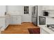 Bright kitchen featuring stainless steel appliances, white cabinets, and hardwood floors at 660 Cranberry Ct, Roswell, GA 30076