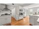 Modern kitchen with white cabinets, stainless steel appliances and hardwood floors at 660 Cranberry Ct, Roswell, GA 30076