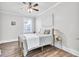 Bedroom features light wood floors and natural light from a window at 11 Poplar St, Porterdale, GA 30014