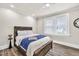 Comfortable bedroom featuring a wood bed frame, wood floors, and bright natural lighting from a double window at 11 Poplar St, Porterdale, GA 30014