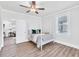 Bright bedroom with light wood floors, four-poster bed, and a large window at 11 Poplar St, Porterdale, GA 30014