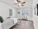 Bedroom with natural light from two windows and light wood floors at 11 Poplar St, Porterdale, GA 30014