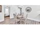 Cozy dining area with a round table set for four, complemented by a decorative mirror and neutral tones at 11 Poplar St, Porterdale, GA 30014