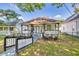 Charming white home with a cozy front porch and well-maintained lawn and attractive landscaping at 11 Poplar St, Porterdale, GA 30014