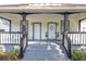 Inviting front porch with a welcoming entrance, complete with a small seating area and manicured greenery at 11 Poplar St, Porterdale, GA 30014