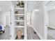 Bright hallway featuring built-in shelving and neutral colors, connecting various rooms within the home at 11 Poplar St, Porterdale, GA 30014