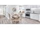 Modern kitchen and breakfast nook features stainless steel appliances and ample counter space at 11 Poplar St, Porterdale, GA 30014