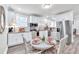 Bright kitchen with stainless steel appliances, granite countertops, and a stylish dining area at 11 Poplar St, Porterdale, GA 30014