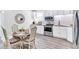 Well-lit kitchen features stainless steel appliances, white cabinets, and a dining table with four chairs at 11 Poplar St, Porterdale, GA 30014