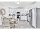 Modern kitchen with stainless steel appliances, bright countertops, and an eat-in breakfast area at 11 Poplar St, Porterdale, GA 30014