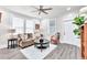 Bright living room with ample natural light, hardwood floors, and comfortable seating at 11 Poplar St, Porterdale, GA 30014