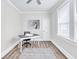 Bright office space featuring a gray desk, neutral walls, a ceiling fan, and natural light at 11 Poplar St, Porterdale, GA 30014