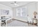 Well-lit office space with a ceiling fan, neutral walls, and a decorative painting at 11 Poplar St, Porterdale, GA 30014