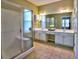 Well-lit bathroom featuring a walk-in shower and double sink vanity with ample counter space at 111 Churchcliff Dr, Woodstock, GA 30188