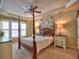 Inviting bedroom features a four poster bed, ceiling fan, and plenty of natural light at 111 Churchcliff Dr, Woodstock, GA 30188