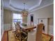 Dining room featuring a tray ceiling, chandelier and a fireplace at 111 Churchcliff Dr, Woodstock, GA 30188